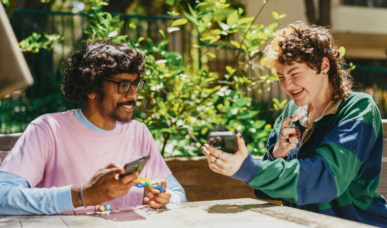 person-showing-mobile-screen-and-smiling